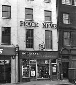 The Peace News logo on the front of 5 Caledonian Road, London, in the 1950s.
